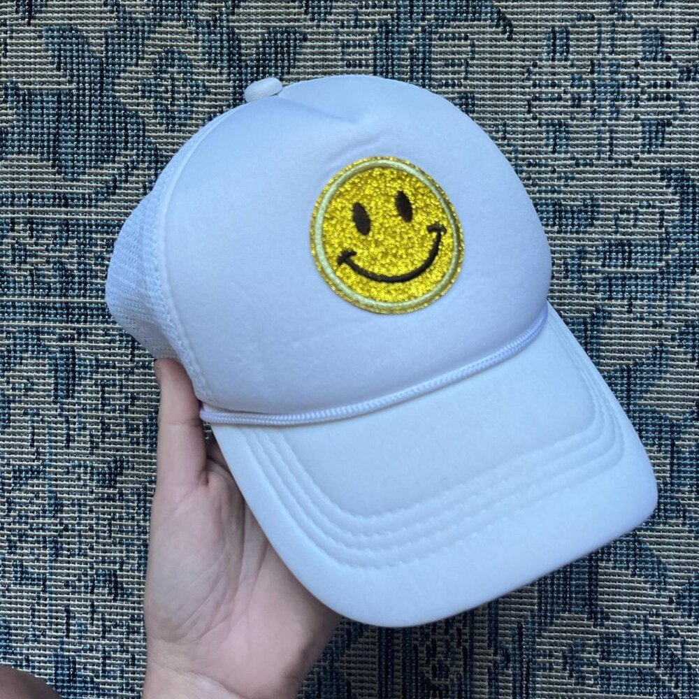 White and gold sparkly smiley face trucker hat